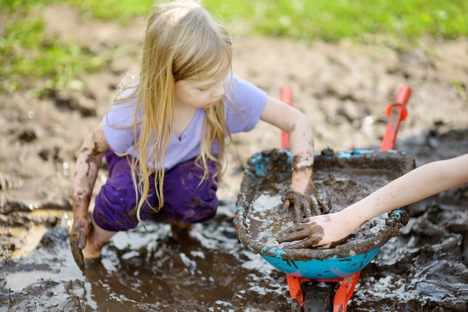 Girl Playing in a Mud Puddle